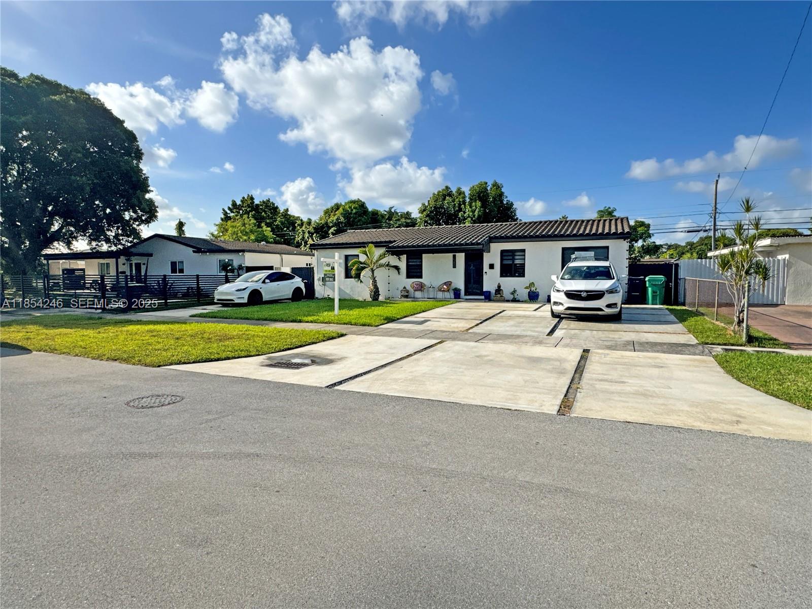 a view of a house with swimming pool and sitting area