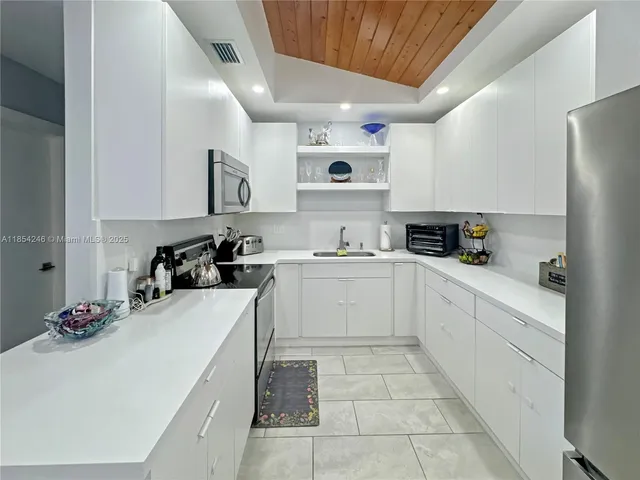 a kitchen with a sink window and cabinets