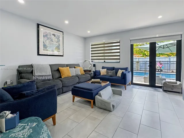 a living room with furniture and large window