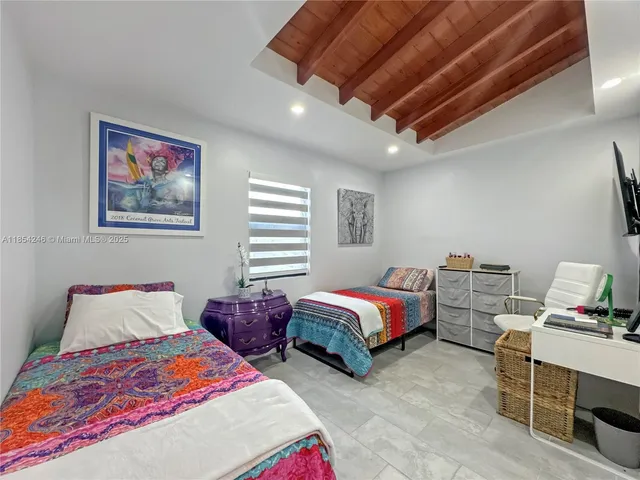 a bedroom with bed and a chandelier