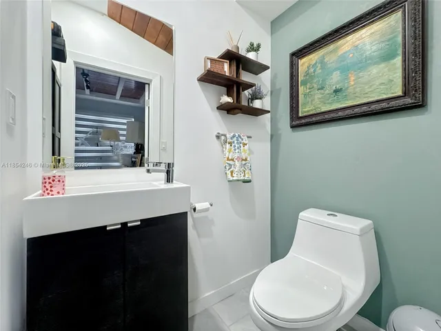 a bathroom with a toilet a sink and mirror