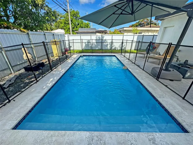 a view of swimming pool with seating space