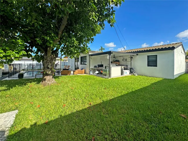 a house view with a sitting space and garden