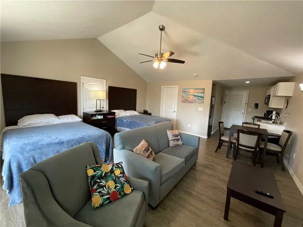 a bedroom with two beds and a couch