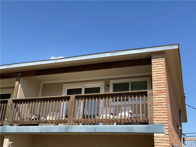 a view of a house with swimming pool and sitting area