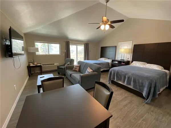 a bedroom with a bed and a large mirror