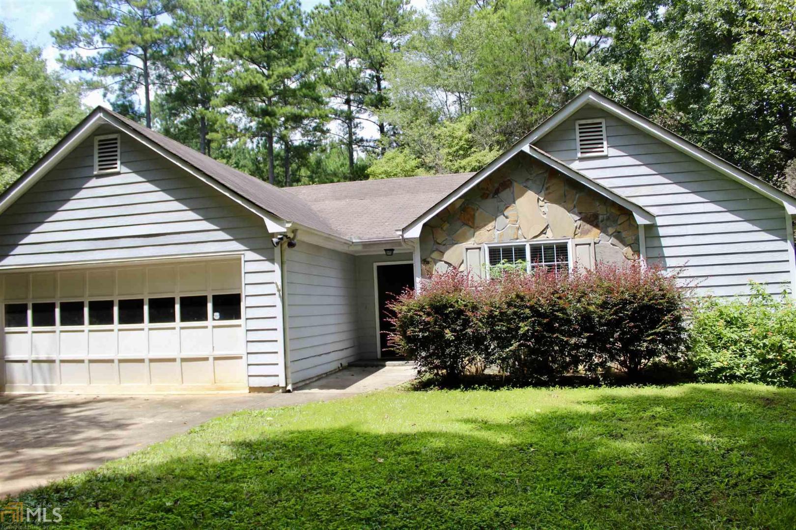 1231 Old Jackson Road Locust Grove, GA 30248 - Photo 1 of 1 a front view of a house with a yard and trees