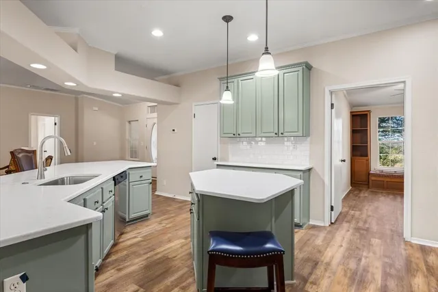 a kitchen with a sink stove and refrigerator