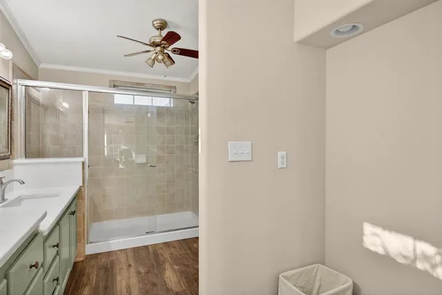 a bathroom with a granite countertop bathtub shower sink vanity and toilet