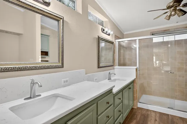 a bathroom with a double vanity sink mirror and shower