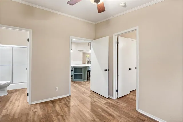 a view of a hallway with wooden floor and closet