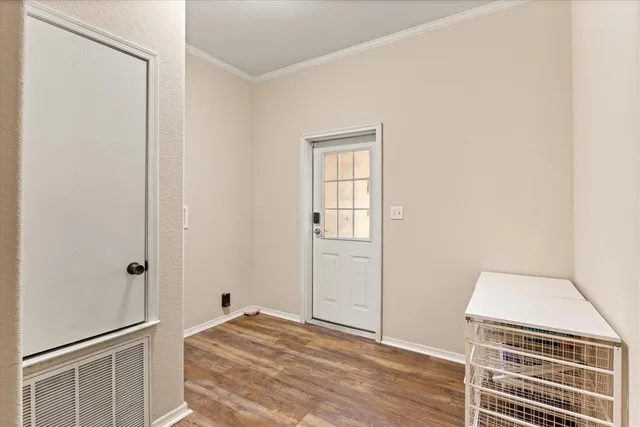 a view of a livingroom with wooden floor and cabinet