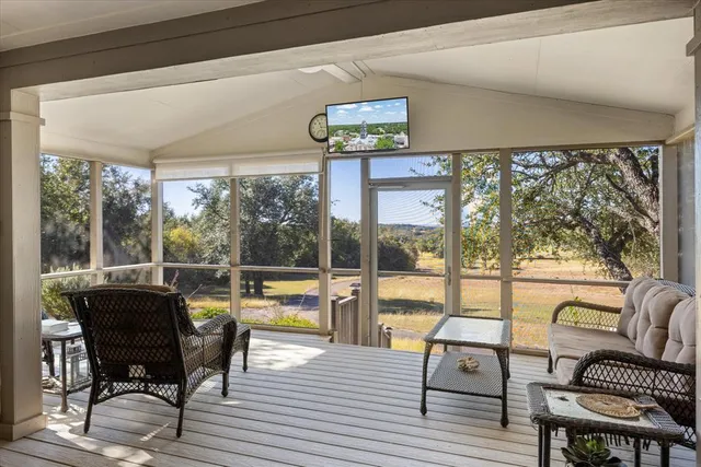a living room with furniture and a floor to ceiling window