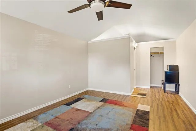 a view of a room with wooden floor