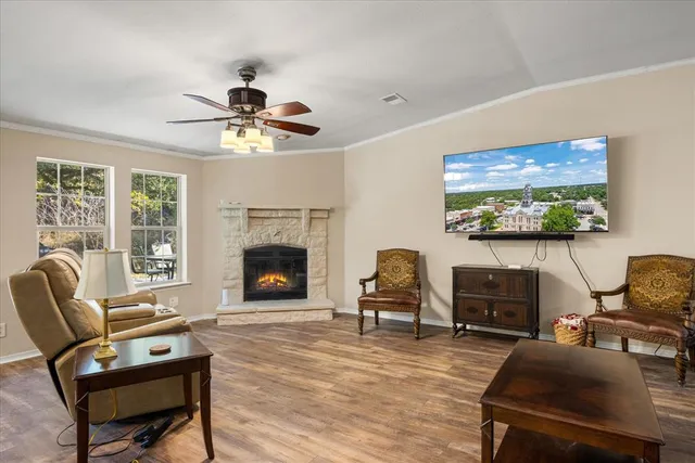 a living room with furniture a window and a fireplace