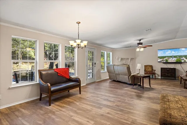 a living room with furniture and a chandelier
