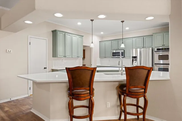 a dining room filled chandelier furniture and kitchen view