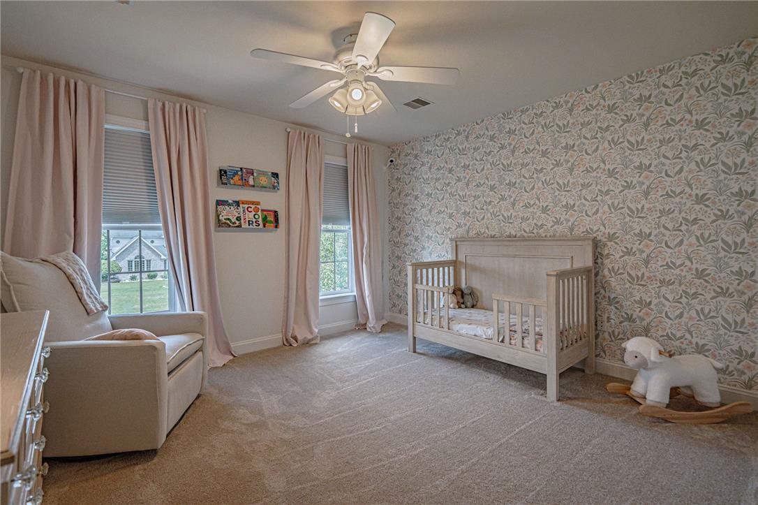 6000 Pond View Terrace Bath, PA 18014 - Photo 44 of 69 A tranquil nursery showcasing elegant floral wallpaper and sun-filled windows.