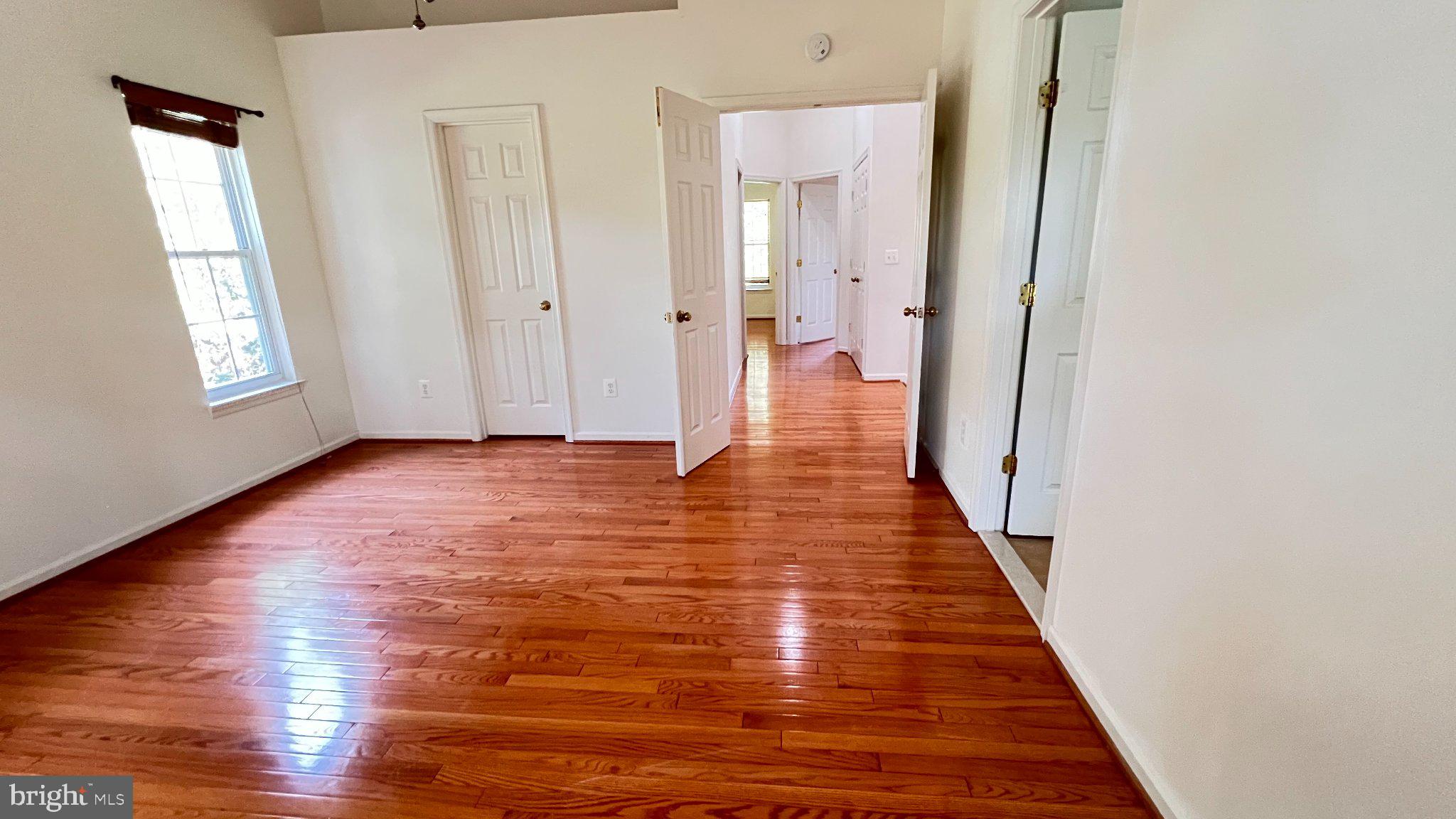 4100 Flower Fairfax, VA 22030 - Photo 29 of 47 a view of a hallway with wooden floor and a bathroom