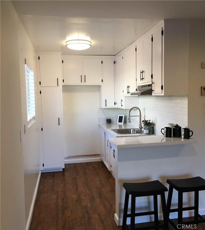 14718 Magnolia Boulevard, Unit 3 Sherman Oaks, CA 91403 - Photo 2 of 5 a kitchen with granite countertop a sink cabinets and refrigerator
