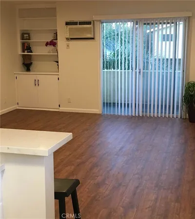 a view of a room with wooden floor and shelf