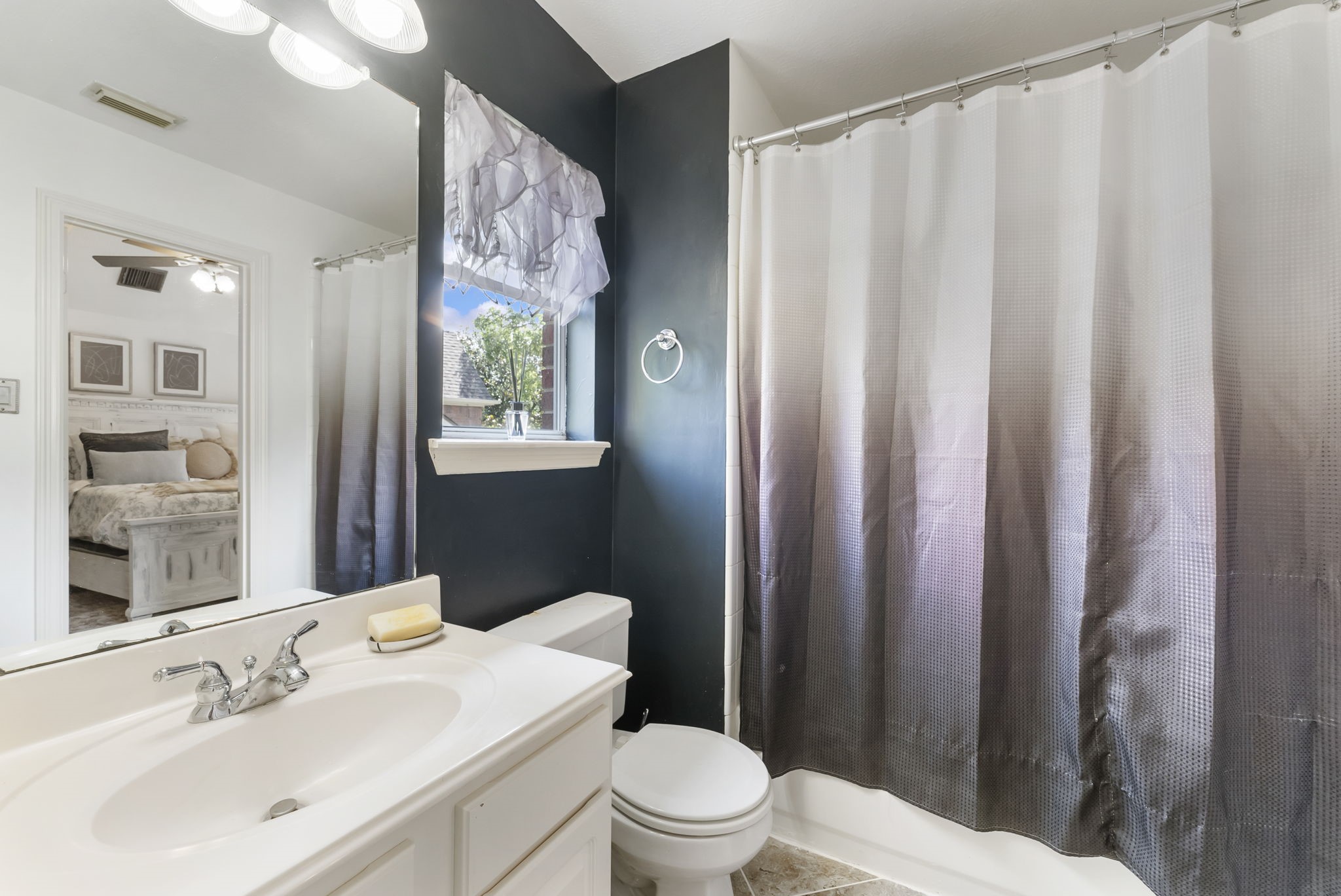12907 Ryaneagles Circle Houston, TX 77044 - Photo 32 of 48 a bathroom with a sink a toilet and shower curtain