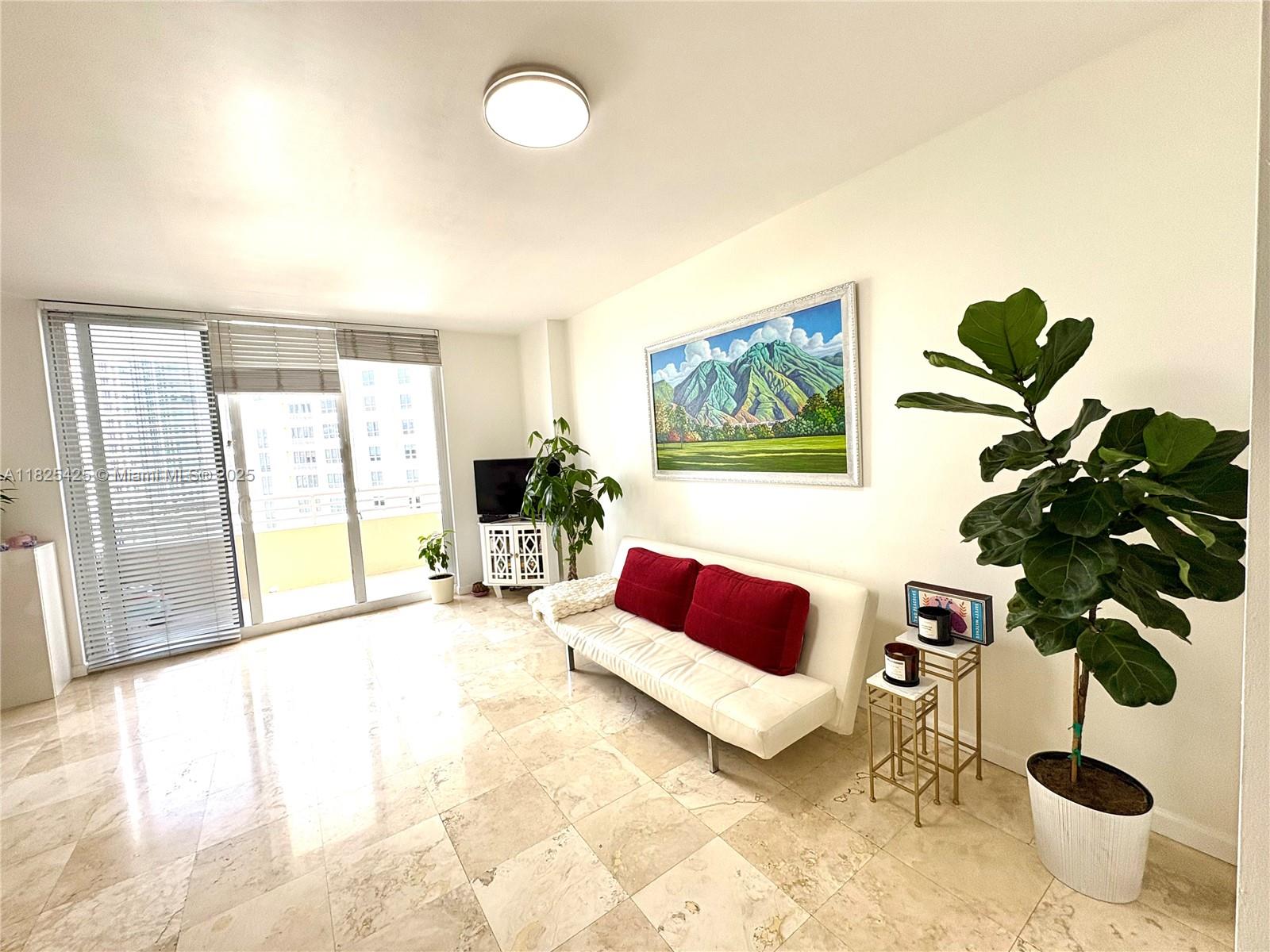 808 Brickell Key Drive, Unit 1103 Miami, FL 33131 - Photo 3 of 12 a living room with furniture and a potted plant