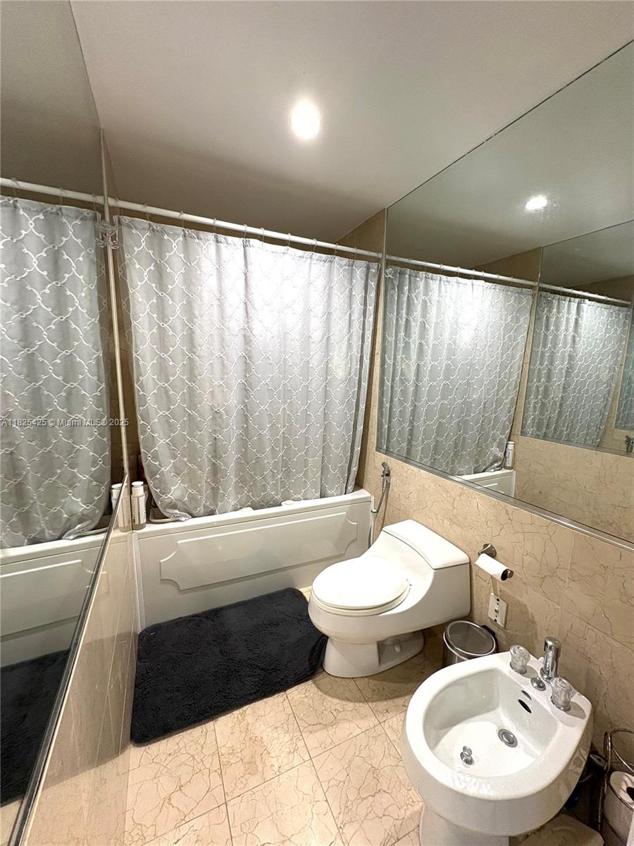 808 Brickell Key Drive, Unit 1103 Miami, FL 33131 - Photo 9 of 12 a bathroom with a sink and a mirror