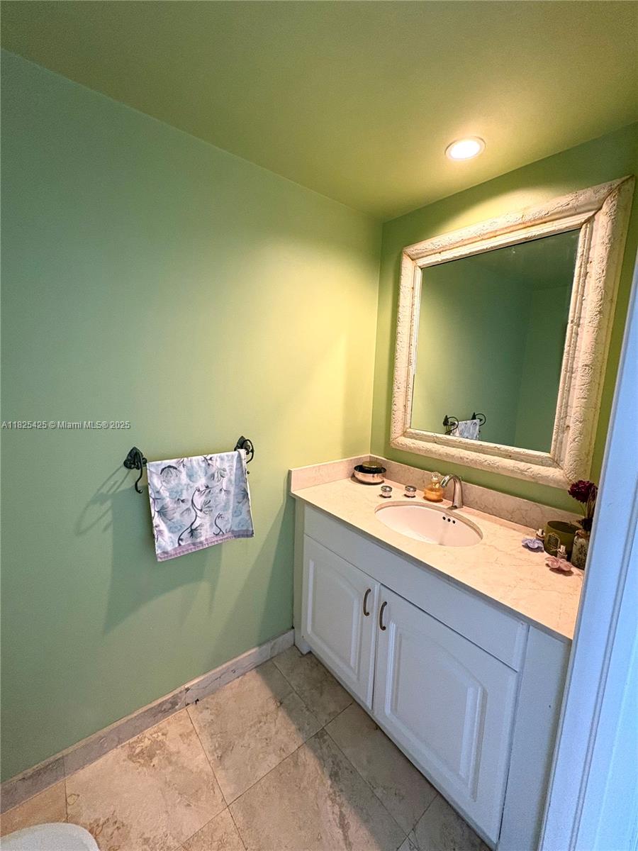 808 Brickell Key Drive, Unit 1103 Miami, FL 33131 - Photo 10 of 12 a bathroom with a sink and a mirror