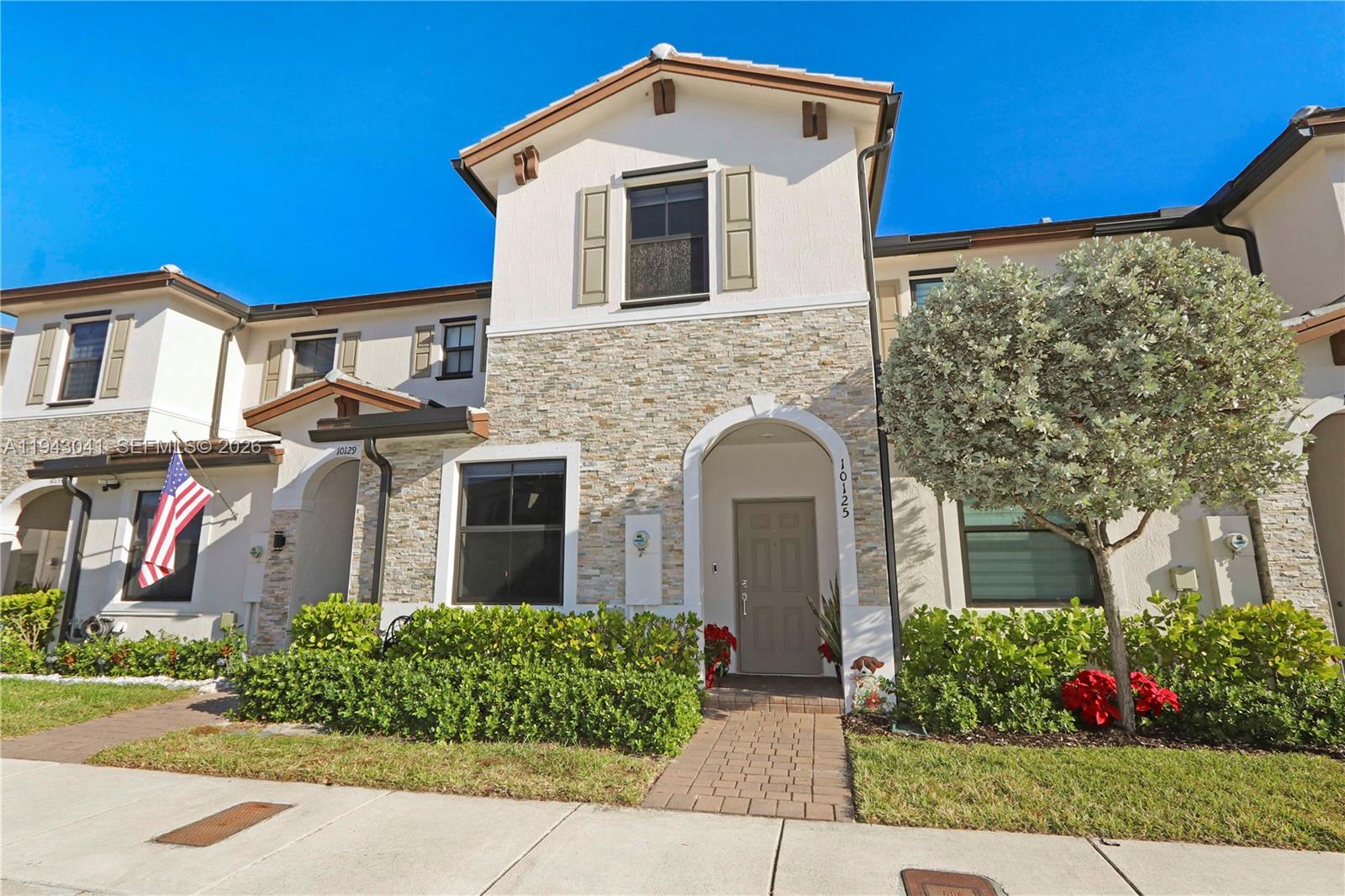 10125 Southwest 228th Terrace Miami, FL 33190 - Photo 1 of 26 a front view of a house with garden