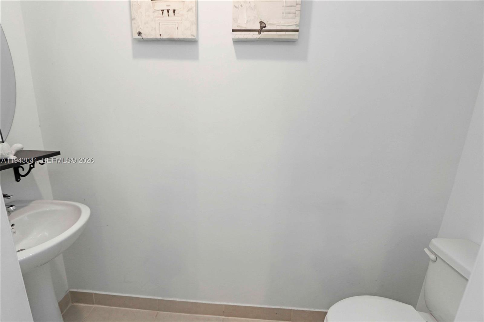 10125 Southwest 228th Terrace Miami, FL 33190 - Photo 14 of 26 a bathroom with a sink and toilet