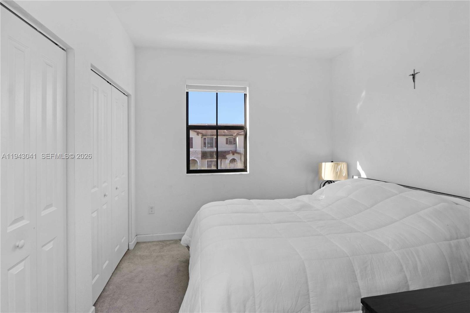 10125 Southwest 228th Terrace Miami, FL 33190 - Photo 17 of 26 a bedroom with a bed and a window