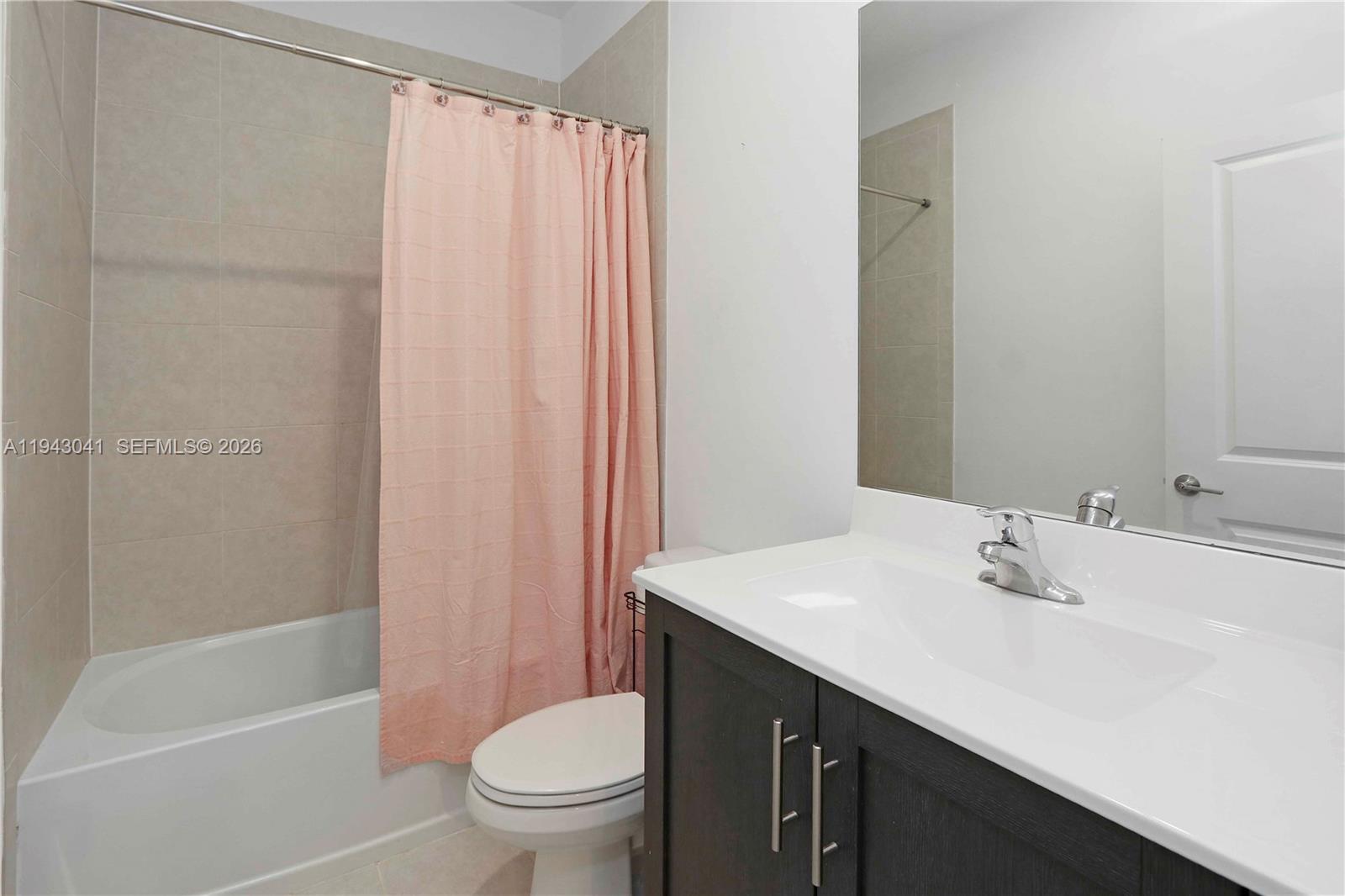 10125 Southwest 228th Terrace Miami, FL 33190 - Photo 19 of 26 a bathroom with a sink a toilet and shower