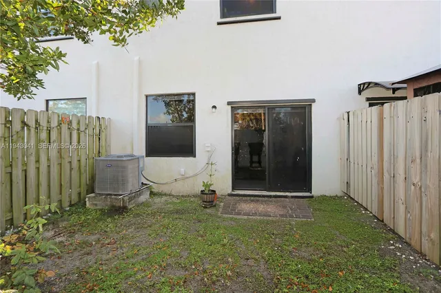 a view of a front door and small yard