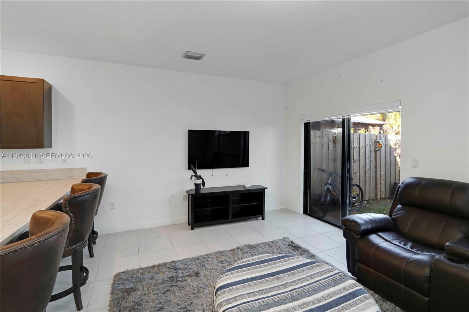 10125 Southwest 228th Terrace Miami, FL 33190 - Photo 9 of 26 a living room with furniture and a flat screen tv
