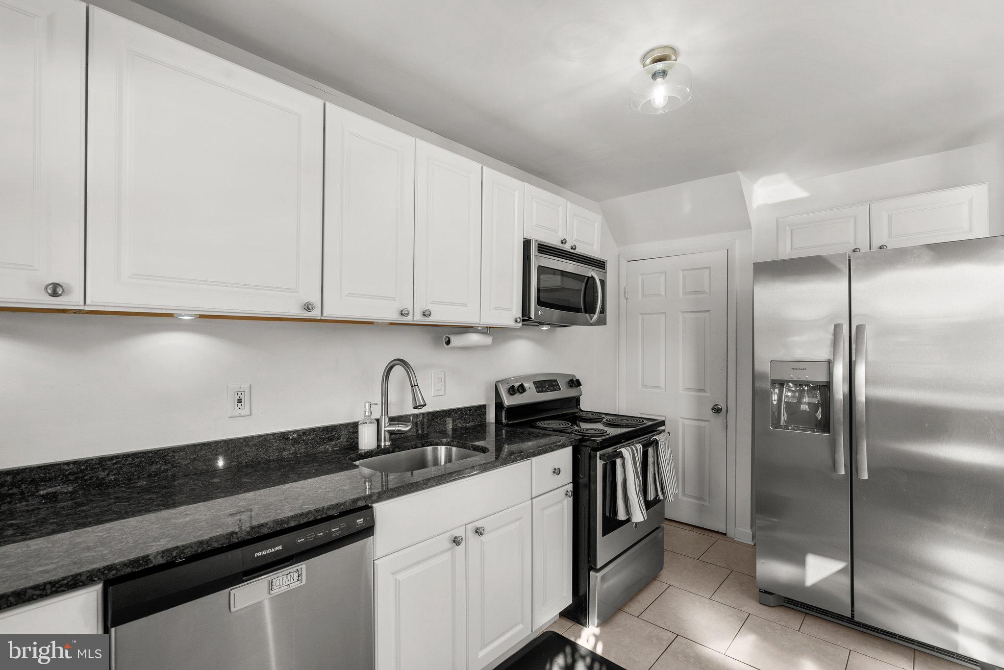 40 Bladen Road Baltimore, MD 21221 - Photo 13 of 44 a kitchen with stainless steel appliances granite countertop a refrigerator a sink and white cabinets