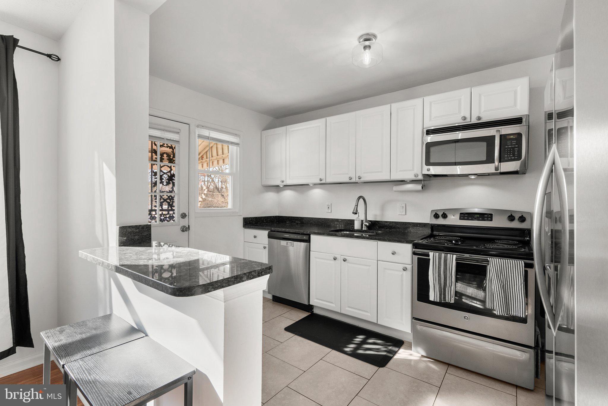 40 Bladen Road Baltimore, MD 21221 - Photo 14 of 44 a kitchen with stainless steel appliances granite countertop a stove microwave and sink