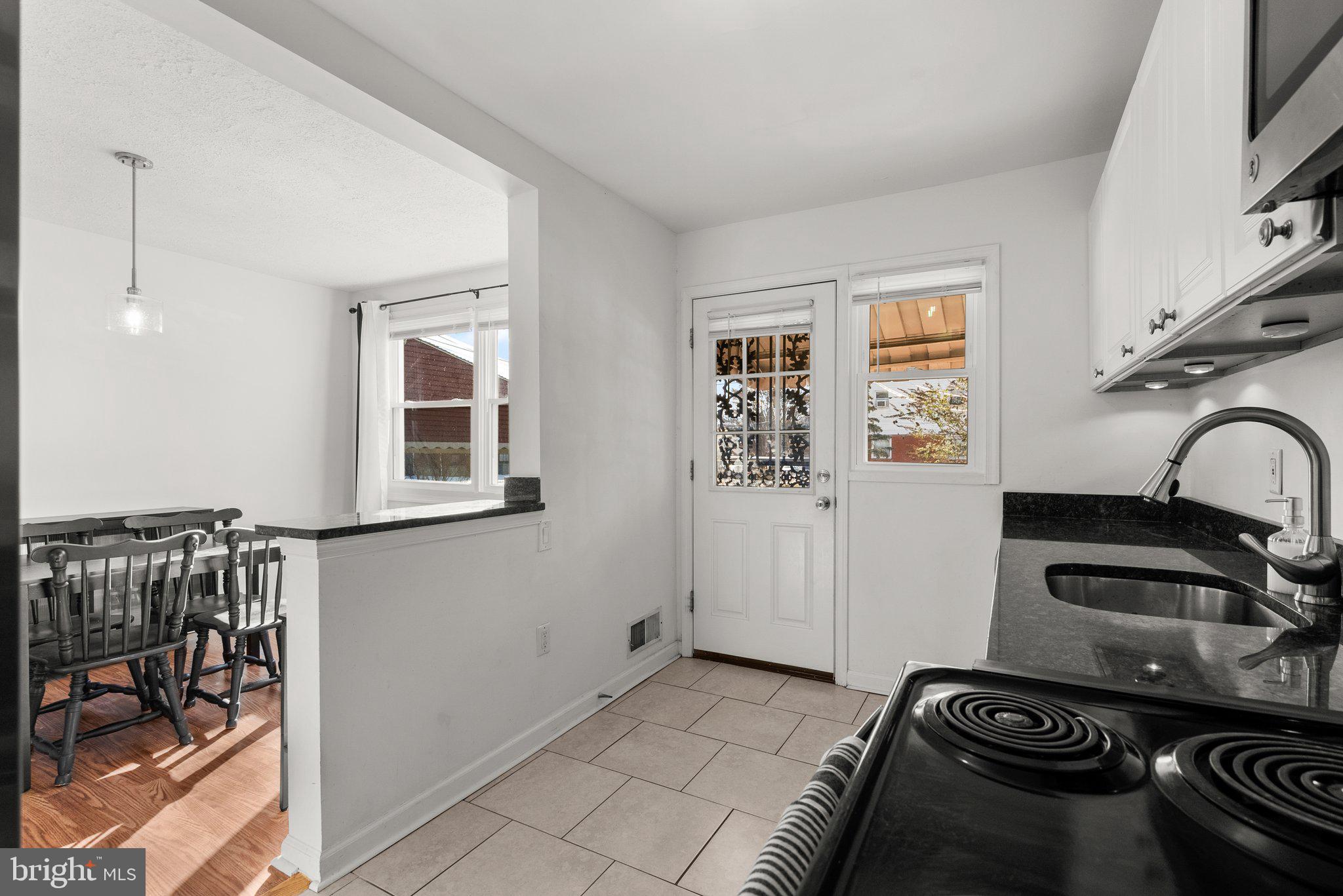 40 Bladen Road Baltimore, MD 21221 - Photo 15 of 44 a kitchen with a sink stove and cabinets