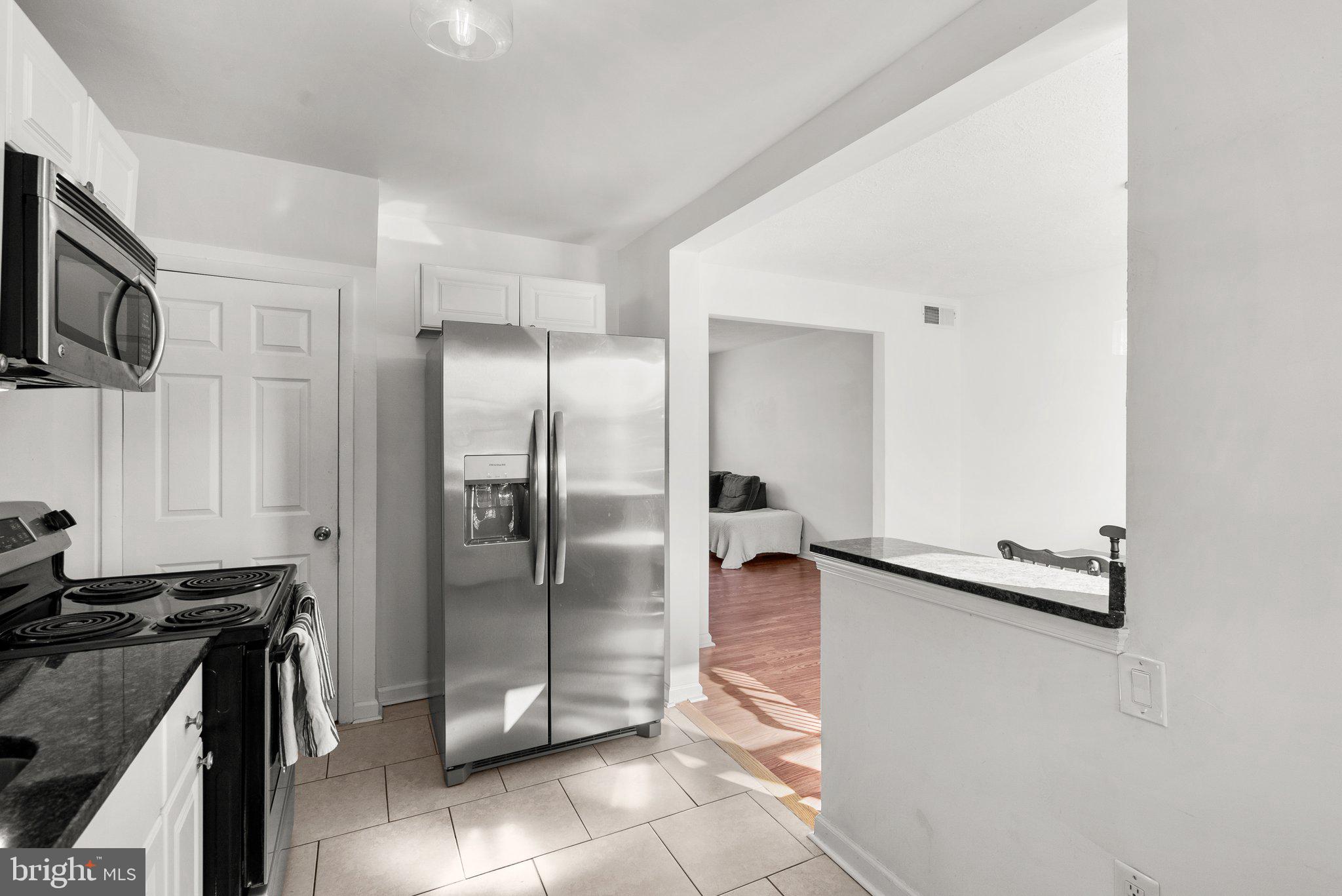 40 Bladen Road Baltimore, MD 21221 - Photo 16 of 44 a kitchen with stainless steel appliances granite countertop a refrigerator and a stove