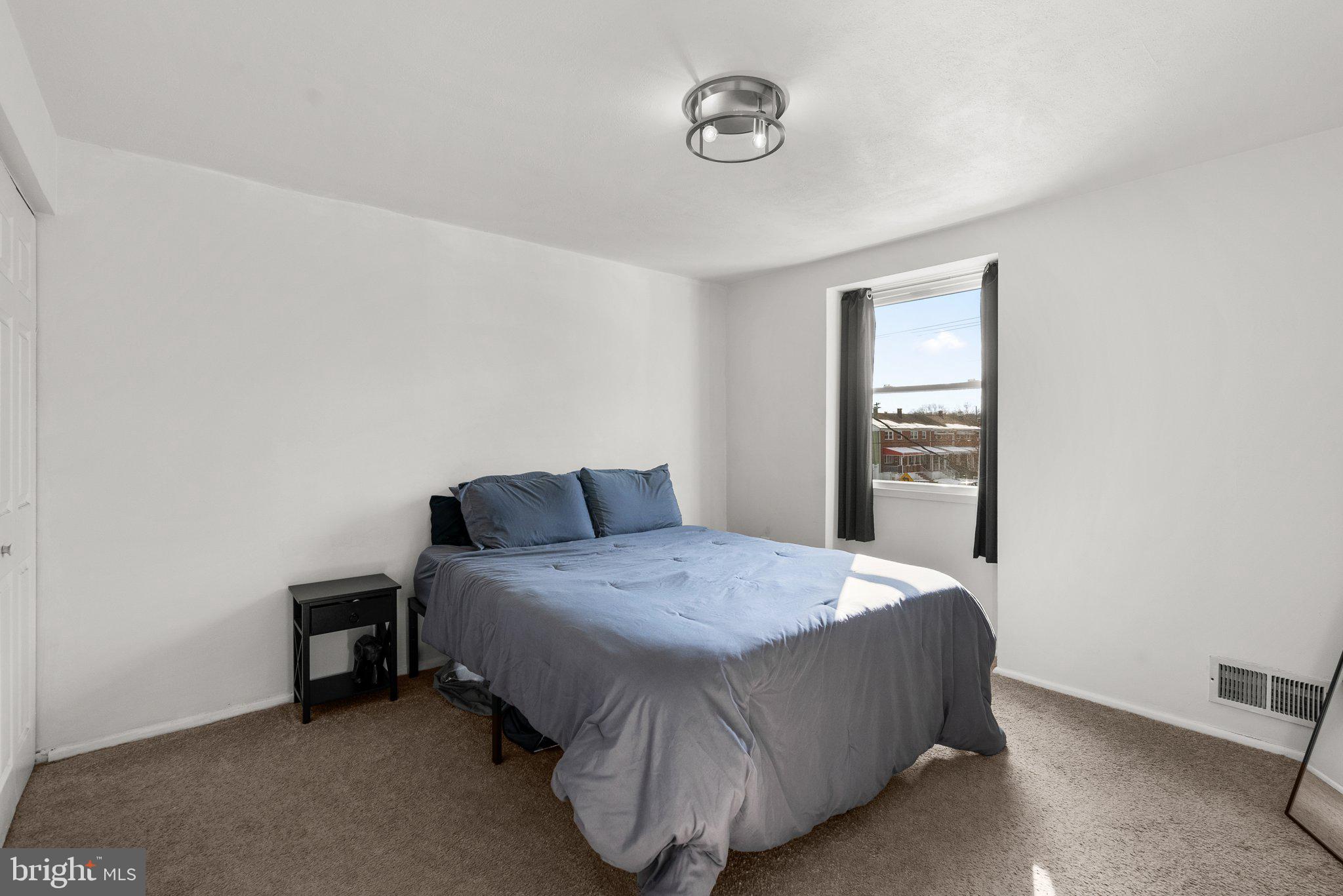 40 Bladen Road Baltimore, MD 21221 - Photo 18 of 44 a bedroom with a bed and a table