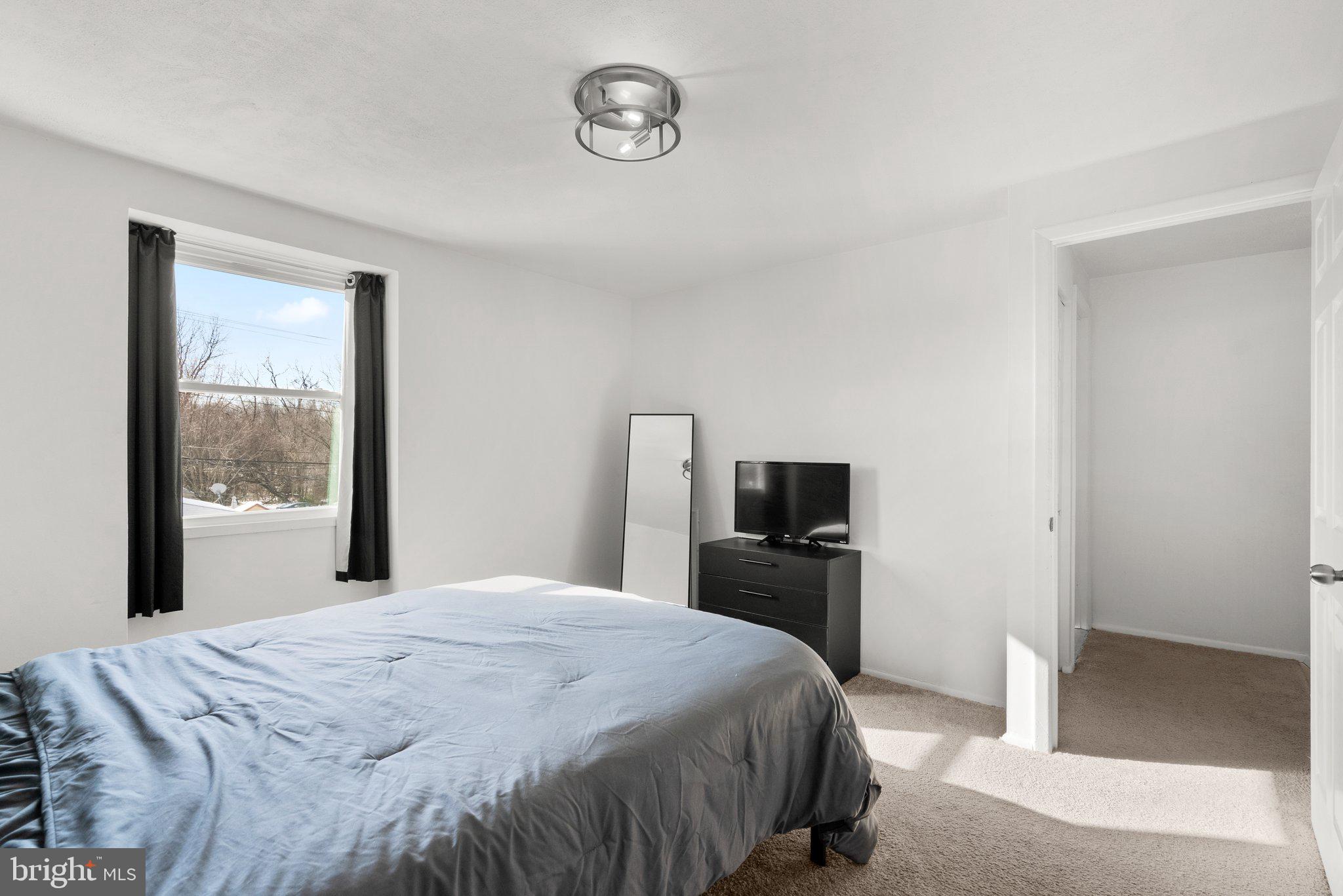 40 Bladen Road Baltimore, MD 21221 - Photo 19 of 44 a bedroom with a bed and a large window