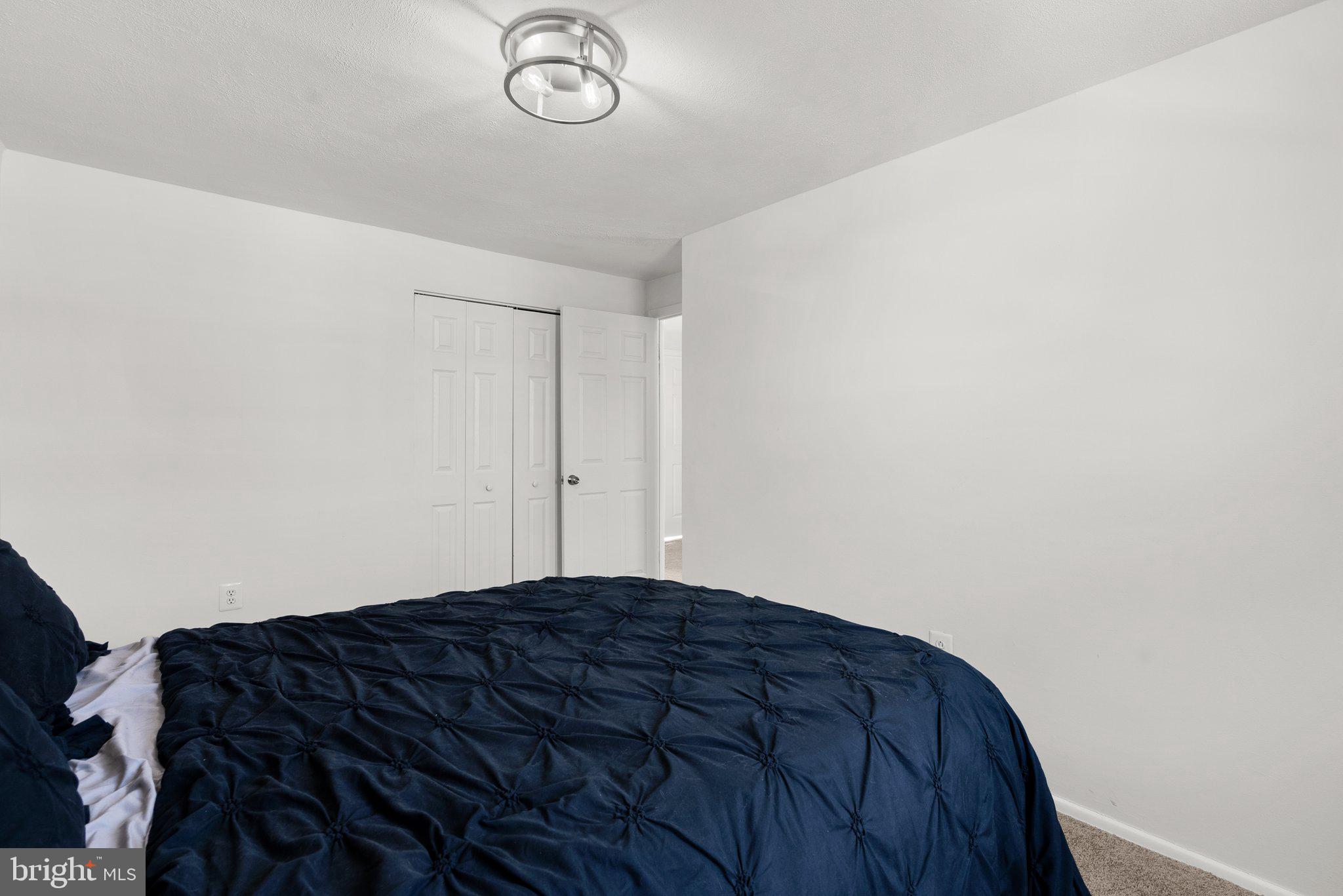 40 Bladen Road Baltimore, MD 21221 - Photo 23 of 44 a bedroom with a bed and a chandelier fan