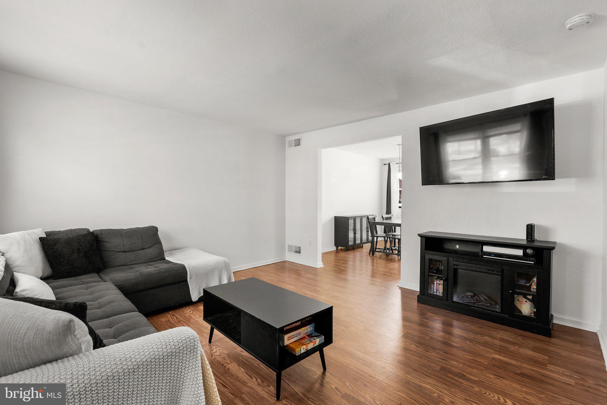 40 Bladen Road Baltimore, MD 21221 - Photo 5 of 44 a living room with furniture a fireplace and a flat screen tv