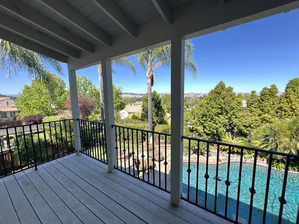 a view of a balcony with wooden floor