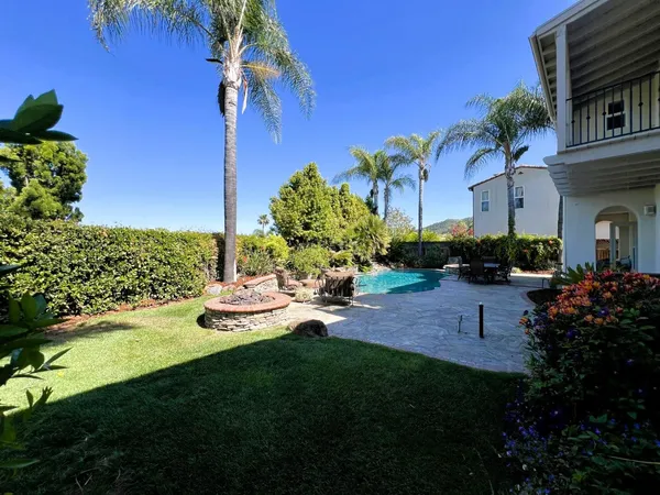 a view of a backyard with plants and a patio
