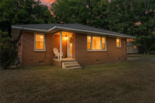 a view of house with backyard and garden