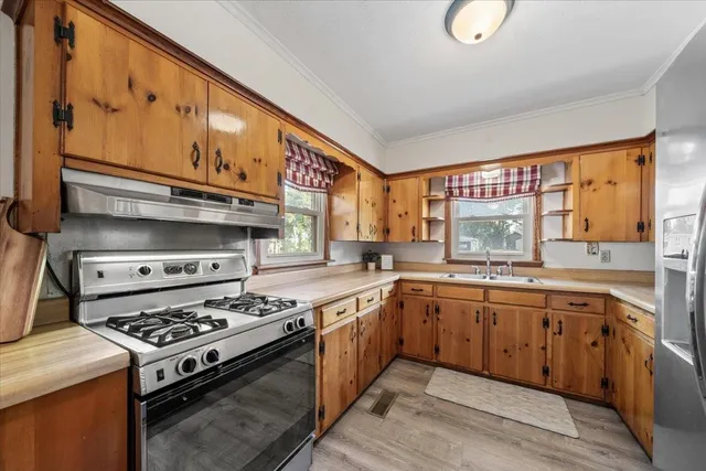 a kitchen with stainless steel appliances granite countertop a stove and a sink