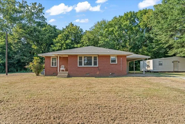 a house that has a tree in front of it