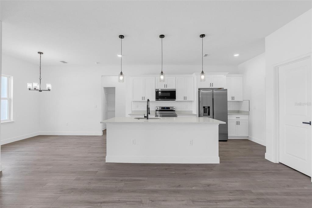 17109 Southwest 41st Circle Ocala, FL 34473 - Photo 14 of 72 a view of kitchen with stainless steel appliances refrigerator stove and wooden floor