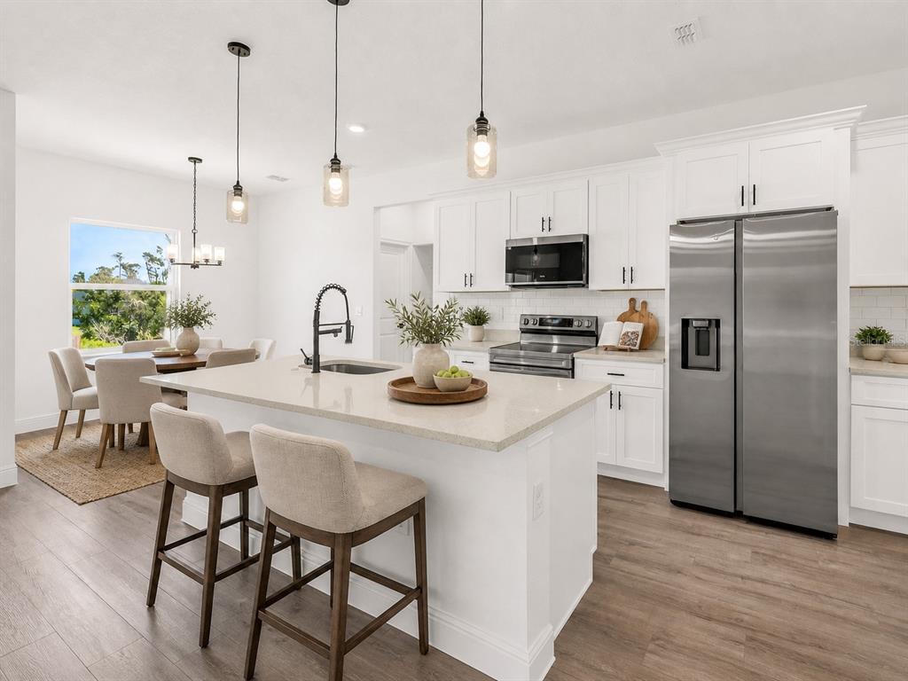 17109 Southwest 41st Circle Ocala, FL 34473 - Photo 16 of 72 a kitchen with refrigerator and chairs